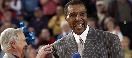 Former Kansas University basketball standout Jo Jo White, right, yuks it up with radioman Max Falkenstien during White's jersey-retirement ceremony in this file photo from 2003. Though he works for the Boston Celtics, White says he keeps close tabs on the Jayhawks.