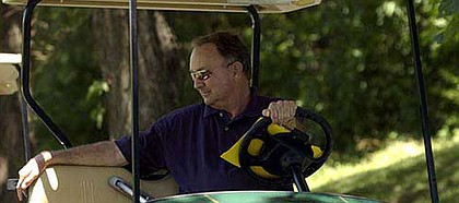 Kansas University golf coach Ross Randall watches the 2003 Be Like Bob Memorial at Alvamar from his golf cart in this file photo. After 30 years of service at KU, Randall retired on Tuesday.