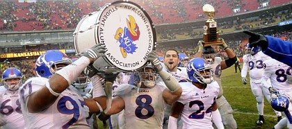Kansas linebacker Joe Mortensen (8) and defensive tackle Richard Johnson Jr. hoist the traveling war drum trophy following the Jayhawks 40-37 victory over rival Missouri, Saturday, Nov. 29, 2008 at Arrowhead Stadium.
