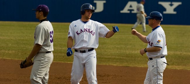 Kansas Freshman Zac Elgie, center, accepts congratulations after singling in the seventh inning of the first game of KU’s doubleheader with Northwestern. The Jayhawks swept the twinbill, 9-8 and 7-3, on Friday at Hoglund Ballpark.