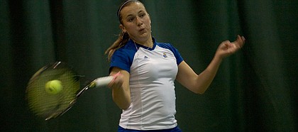 Kansas University’s Kate Morozova returns a shot during doubles play against Texas A&M. The Jayhawks fell to the Aggies, 6-1, Sunday at First Serve Tennis Center.