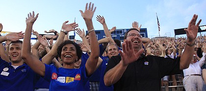 Kansas University’s new chancellor Bernadette Gray-Little, along with KU men’s basketball coach Bill Self, wave the wheat with thousands of new students at Traditions Night on Monday at Memorial Stadium.