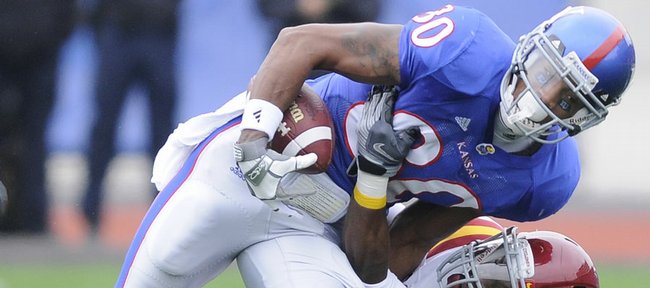 Kansas receiver Dezmon Briscoe is dragged down by Iowa State defensive back David Sims after a catch during the first quarter, Saturday, Oct. 10, 2009 at Kivisto Field.