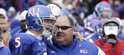 Kansas Quarterback Todd Reesing (5) chats with coach Mark Mangino after scoring against Iowa State. Mangino praised his quarterback Monday, saying Reesing deserves to be in the conversation for the Heisman Trophy.