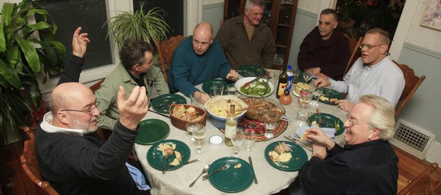 From lower left, David Frayer, Wayne Propst, Kevin Whitehead, Karl Gridley, Robert J. Antonio, James Grauerholz and Jay Sayre have an evening meal together. For more than 30 years, the group calling itself the Bimbo Club has gathered for food, drink and good company. The group members dined at David Frayer’s house on Jan. 14. Women do join the Bimbo Group, which is named for a type of white bread popular in the South.
