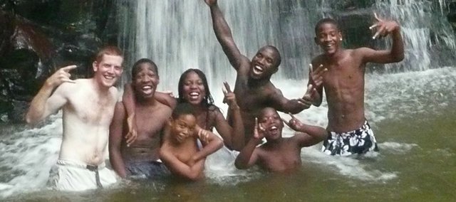 Kansas University Peace Corps representative Ben Wiechman swims with friends at a waterfall in Saint Lucia while serving abroad for the Peace Corps.
