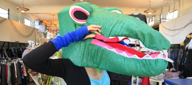 Kendra Davis, assistant manager of Social Service League, 905 R.I., tries on store gear perfect for an inexpensive Halloween getup. 