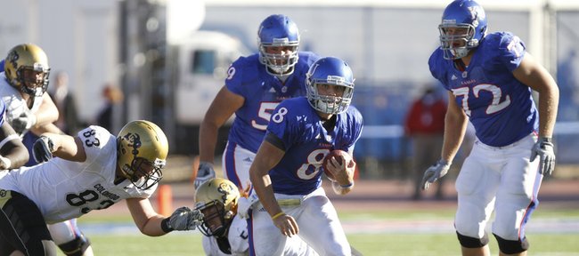 Kansas quarterback Quinn Mecham (8) runs through a hole in the Colorado defense during the fourth quarter of the Jayhawks’ 52-45 victory Saturday at Memorial Stadium.