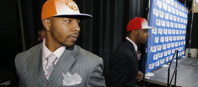 Twin brothers Markieff , left, and Marcus Morris, who played together at Kansas, stand near the stage after they were picked No. 13 and No. 14, respectively, during the NBA basketball draft Thursday, June 23, 2011, in Newark, N.J. Markieff was picked by the Phoenix Suns while Marcus was picked by the Houston Rockets.