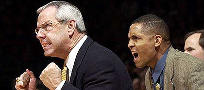 Neil Dougerty, right, is shown alongside former KU coach Roy Williams in this 2002 file photo. CBSSports.com is reporting that Dougherty has died at the age of 50.