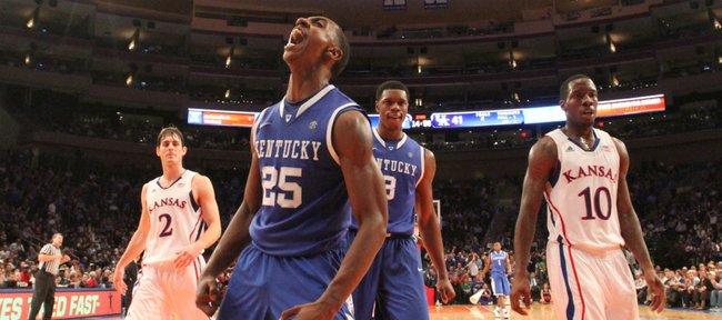 Kentucky guard Marquis Teague celebrates a dunk in front of Kansas players Tyshawn Taylor (10) Conner Teahan (2) and teammate Terrence Jones during the second half on Tuesday, Nov. 15, 2011 at Madison Square Garden in New York.