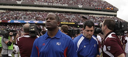 Kansas head coach Turner Gill walks off the field after falling to Texas A&M, 61-7, Saturday, Nov. 19, 2011 at Kyle Stadium in College Station, Texas.