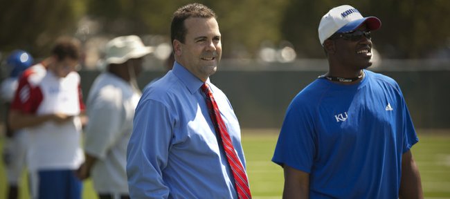 Kansas athletic director Sheahon Zenger hangs out with head coach Turner Gill on the sidelines of practice in this Aug. 16 file photo. Zenger announced Gill was fired on Sunday.
