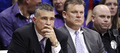 Kansas State head coach Frank Martin, left, and assistant Brad Underwood sit quietly on the bench late in the second half on Wednesday, Jan. 4, 2012 at Allen Fieldhouse.