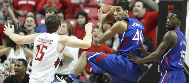 Kansas forward Kevin Young is supported by teammate Elijah Johnson as he comes down with a rebound before Texas Tech center Robert Lewandowski during the first half on Wednesday, Jan. 11, 2012 at United Spirit Arena.