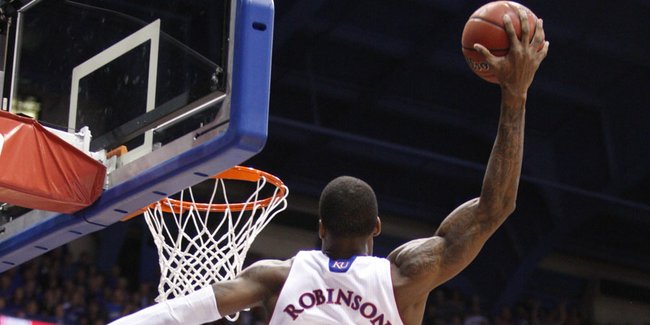 Kansas forward Thomas Robinson gets up for an alley-oop over Baylor defenders Perry Jones III and Anthony Jones (41) during the first half on Monday, Jan. 16, 2012 at Allen Fieldhouse.