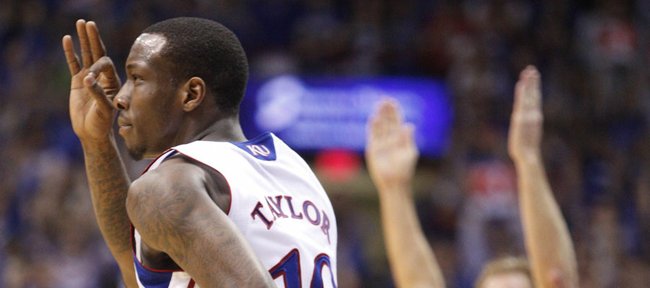 Kansas guard Tyshawn Taylor signals "three" after a bucket against Baylor during the first half on Monday, Jan. 16, 2012 at Allen Fieldhouse.