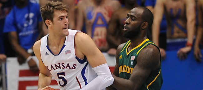 Kansas University center Jeff Withey (5) muscles his way past Baylor’s Qunicy Acy, right, on Monday in Allen Fieldhouse.