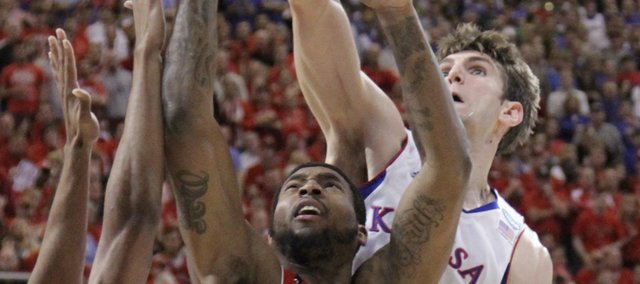 Jeff Withey, right, blocks a shot by Richard Howell (1) in the firsthalf of KU's game against North Carolina State in St. Louis Friday, March 16, 2012.