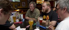 Members of the Team Channel Four news Team, from left, Matt Parker, George Parker, Patrick Funston and Arnie Knudson, all of Lawrence, work out an answer to a question as they play trivia April 15 at Bigg’s Barbecue, 2429 Iowa.