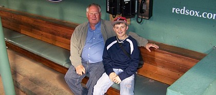 Lawrence’s Marty Pattin, left, poses with grandson Bailey Pattin, a middle-infielder for Perry-Lecompton High, in a Fenway Park dugout. The elder Pattin was among the former Red Sox honored recently before a game at the venerable Boston ballyard.