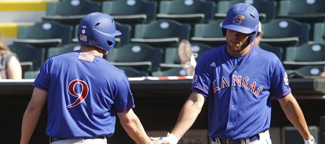 Kansas' Tucker Tharp (6) is congratulated by teammate Zac Elgie, right, after scoring against Texas A&M in the sixth inning of a Big 12 conference tournament college baseball game in Oklahoma City, Wednesday, May 23, 2012. Texas A&M won 10-4, but will face the Jayhawks in a rematch today after KU defeated the Texas Longhorns, 4-2.