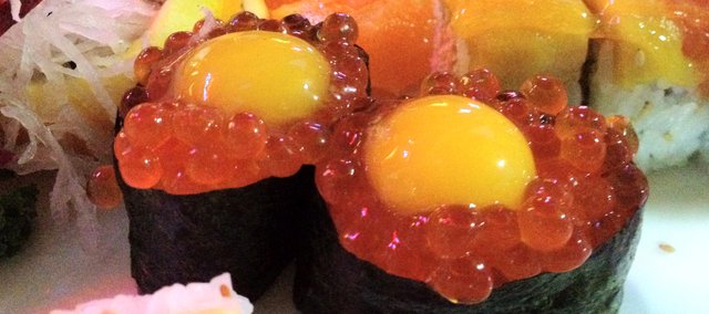 Ikura nigiri sushi, topped with raw quail eggs, at Wa, 740 Mass.