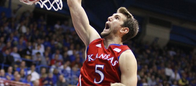 Kansas center Jeff Withey dunks as Washburn forward Bobby Chipman watches during the second half on Monday, Nov. 5, 2012 at Allen Fieldhouse.