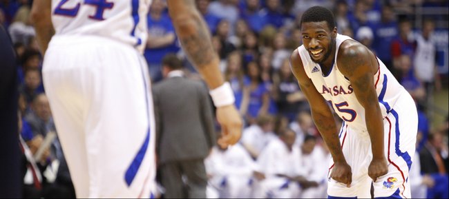 Kansas guard Elijah Johnson smiles after a dunk by teammate Travis Releford against Belmont during the first half on Saturday, Dec. 15, 2012 at Allen Fieldhouse.
