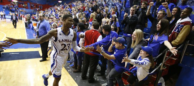 Kansas fans reach to slap hands with Ben McLemore as he exits the floor after a 33-point performance and a game-tying three that send the game into overtime on Wednesday, Jan. 9, 2013 at Allen Fieldhouse.
