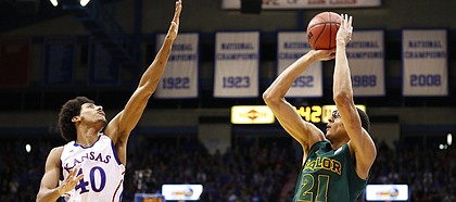 Kansas forward Kevin Young comes in to defend against a three-point shot from Baylor center Isaiah Austin during the second half on Monday, Jan. 14, 2013 at Allen Fieldhouse.