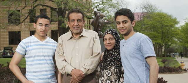 Salam Al Ghafli and his mother Fatimah will both graduate from KU on Sunday with bachelor's degrees. Salam and Fatimah took six classes together, and at Fatimah's insistence, sat side by side in the front row. Gathered Thursday in front of Strong Hall from left are Salam's brother Hassan Al Ghafli, his father Mansour Al Ghafli, his mother Fatimah Al Ghafli and Salam.
