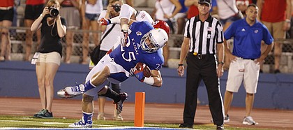 Kansas running back Brandon Bourbon falls into the endzone for a touchdown against South Dakota during the fourth quarter on Saturday, Sept. 7, 2013 at Memorial Stadium.