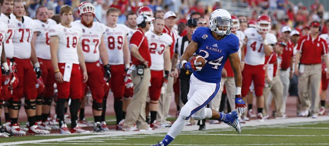 Kansas University punt returner Connor Embree heads up the sideline near the South Dakota bench during a return in the second quarter on Saturday, Sept. 7, 2013, at Memorial Stadium. KU coach Charlie Weis thinks Embree, a former walk-on in his first scholarship season with the Jayhawks, can be one of the best returners in the Big 12 Conference this year.