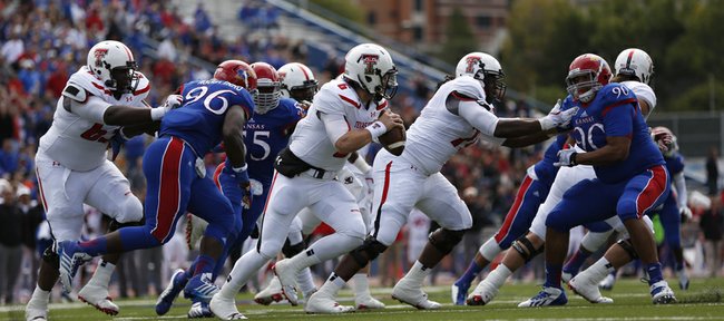 Kansas defenders chase after Texas Tech quarterback Baker Mayfield during the second quarter on Saturday, Oct. 5, 2013 at Memorial Stadium.