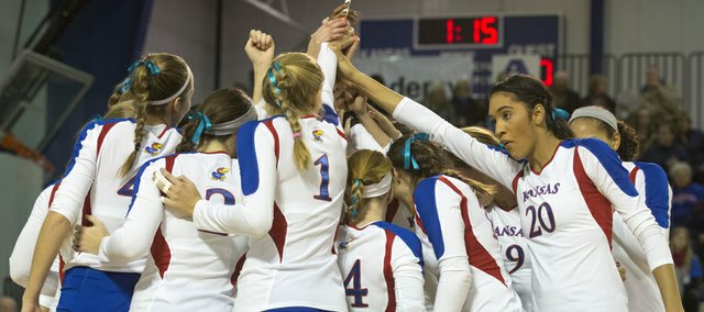 Senior Catherine Carmichael (20) and her Kansas University volleyball teammates come together before the start of their volleyball match against West Virginia, Wednesday, Nov. 6, 2013, at Horejsi Center.
