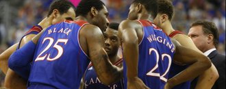 Kansas players and head coach Bill Self huddle together in the second half on Tuesday, Dec. 10, 2013 at O'Connell Center in Gainesville, Florida.
