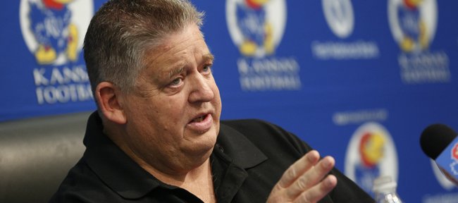 Kansas head football coach Charlie Weis talks with media members during a news conference, Thursday, Dec. 19, 2013 at Mrkonic Auditorium. Weis spent some time discussing changes to the coaching structure, areas for improvement and his staff's recruiting efforts. Nick Krug/Journal-World Photo