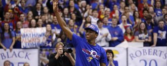 Kansas guard Andrew Wiggins, who most likely will enter the NBA Draft waves to the fieldhouse prior to the senior speeches on Wednesday, March 5, 2014 at Allen Fieldhouse.
