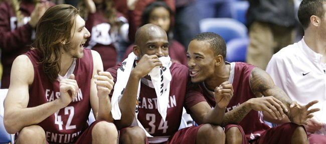 Eastern Kentucky players Eric Stutz (42), Tarius Johnson (34) and Orlando Williams celebrate in the final seconds of a 79-73 win over Belmont in an NCAA college basketball game for the Ohio Valley Conference men's tournament title, Saturday, March 8, 2014, in Nashville, Tenn.