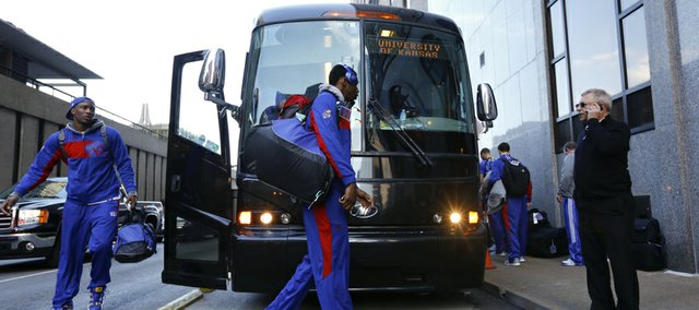 Kansas guard Andrew Wiggins, center, and Jamari Traylor exit the team bus after arriving outside the Hyatt Regency hotel at the Arch, Wednesday, March 19, 2014, in St. Louis. The Jayhawks play their first game of the NCAA Tournament on Friday.