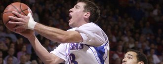 In this file photo from Feb. 16, 2002, Kansas guard Jeff Boschee (13) drives for a basket past Baylor defender Kevin Henry as KU’s Drew Gooden looks on. Boschee says he’s “full of energy” after taking over as head basketball coach at Division-II Missouri Southern State University.
