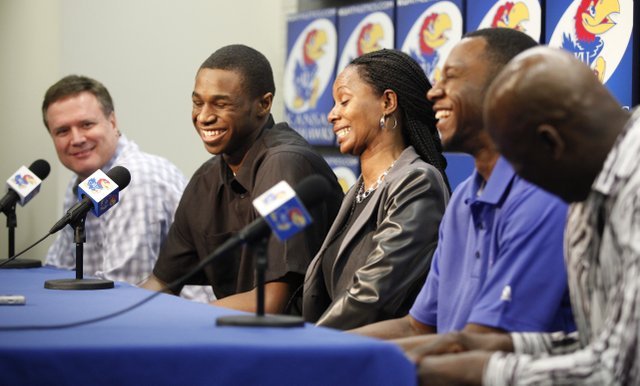 Kansas guard Andrew Wiggins laughs with Jayhawks' head coach Bill Self after Self made a joke about how he could still come back during a news conference in which Wiggins declared his intention to enter the NBA Draft on Monday, March 31, 2014 at Allen Fieldhouse. To his right are his mother Marita Wiggins, brother Mitchell Wiggins Jr. and father Mitchell. Nick Krug/Journal-World Photo