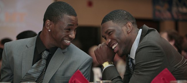 One-and-done freshmen Andrew Wiggins, left, and Joel Embiid share a laugh during the Kansas University men’s basketball postseason awards banquet Tuesday, April 15, 2014, at the Lawrence Holiday Inn. Wiggins, who was given the Danny Manning “Mr. Jayhawk” Award, and Embiid declared for this summer’s NBA Draft after one season at KU.
