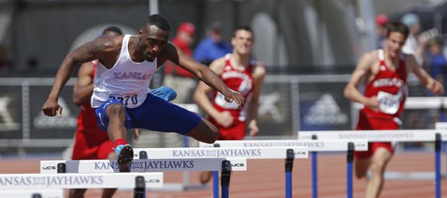 Kansas hurdler Michael Stigler glances over at the crowd as he clears a hurdle during the Mens 400 Meter Hurdles event of the Kansas Relays on Saturday, April 19, 2014 at Rock Chalk Park. Nick Krug/Journal-World Photo