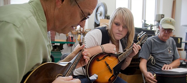 Lawrence musician Scott Tichenor, left, gives mandolin instruction to Jessica Hawkins, Lawrence, during a mandolin workshop in 2009 taught by Tichenor at Mass Street Music, 1347 Mass. The free Tuesday Concert Series features No Mountain String Band, of which Tichenor is a member, 7:30-8:30 p.m. at the Lawrence Arts Center, 940 New Hampshire St.