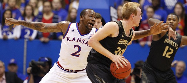 Kansas forward Cliff Alexander reaches to defend against a pass from Emporia State forward Josh Pedersen during the first half on Tuesday, Nov. 11, 2014.