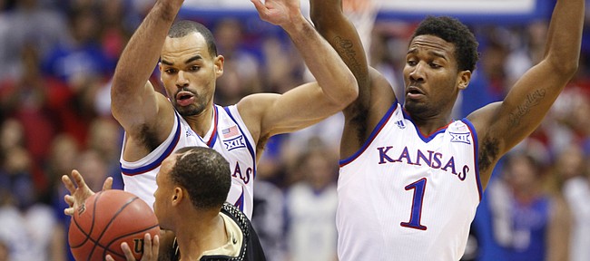 Kansas defenders Perry Ellis, left, and Wayne Selden look to trap Emporia State guard Terrence Moore during the second half on Tuesday, Nov. 11, 2014.