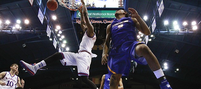 Kansas forward Cliff Alexander delivers a jam against UC Santa Barbara players Gabe Vincent (2) and Alan Williams during the second half on Friday, Nov. 14, 2014 at Allen Fieldhouse.