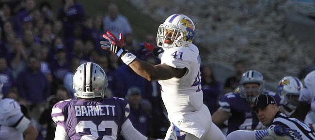 After an attempted catch, Kansas wide receiver Jimmay Mundine (41) tips the ball toward Wildcat cornerback Dante Barnett (22) who made the interception in the Jayhawks game against the Kansas State Wildcats Saturday in Manhattan. .